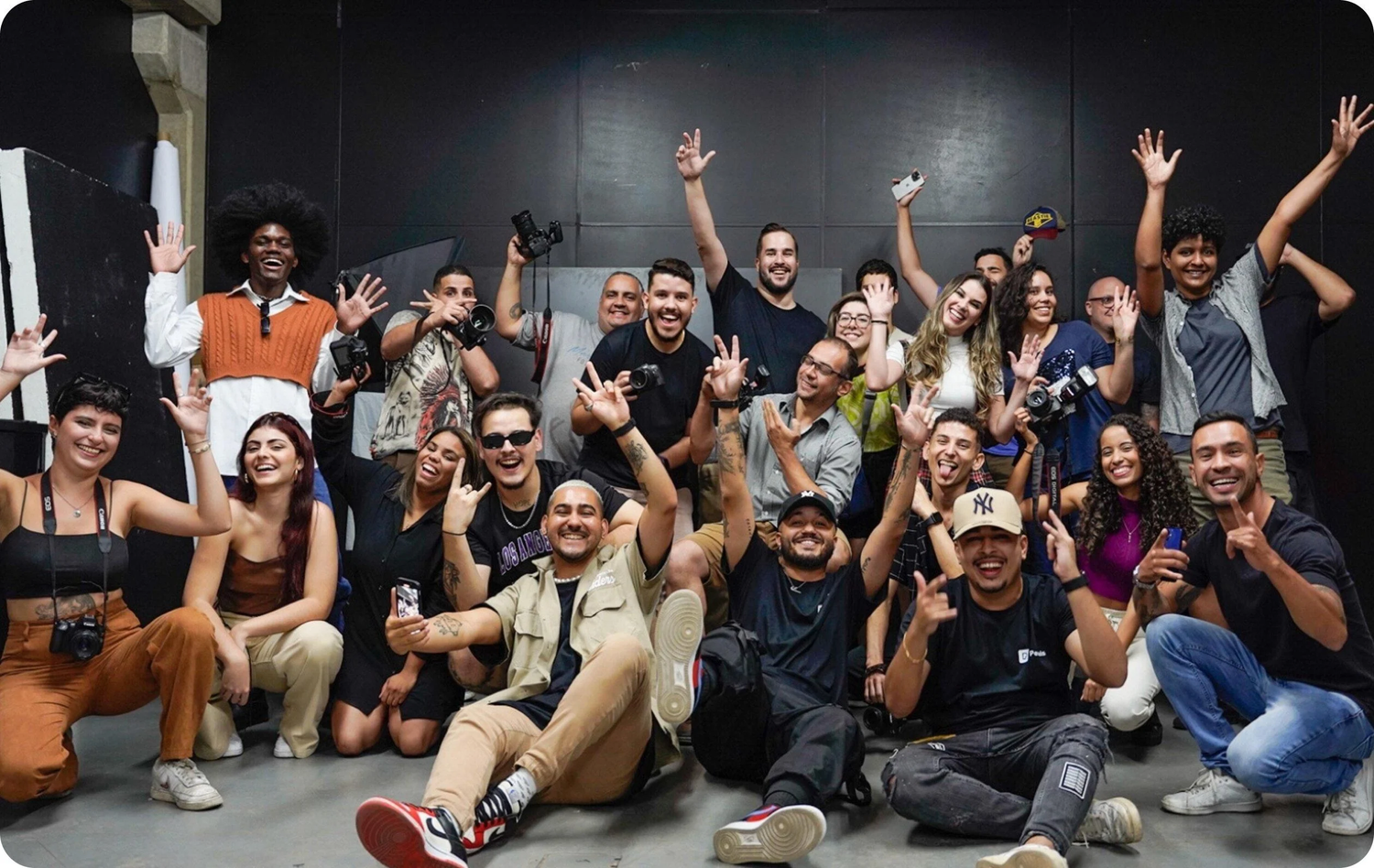 Smart Caffeine community group photo version 2 showing diverse team of people celebrating together in a studio setting